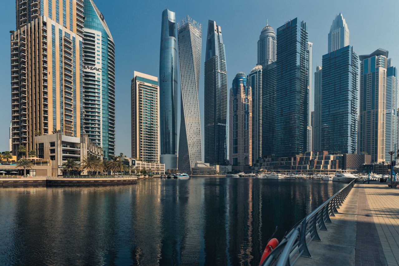 Offerings Explore the towering skyscrapers of Dubai Marina reflecting beautifully on the water.