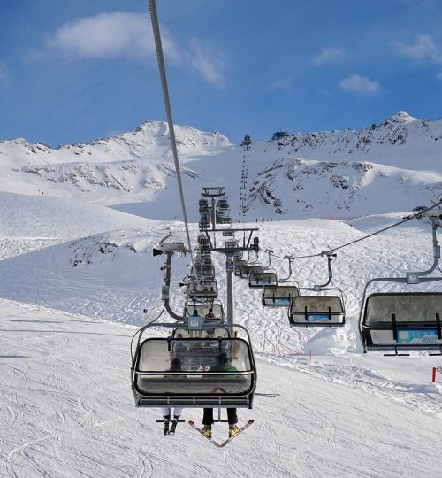 Ski lift chair lift on snowy mountain slope in winter sports resort